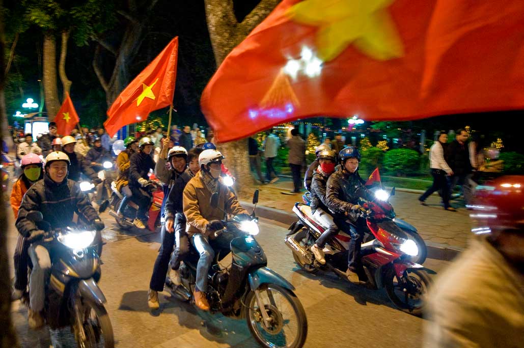 image of AARONTAIT COPYRIGHTED 2014 467 VIETNAM GLORY VICTORY FOOTBALL CELEBRATION HANOI FANS PATRIOTISM HAPPY RIOT FLARE DOCUMENTARY REPORTAGE PHOTOGRAPHER 