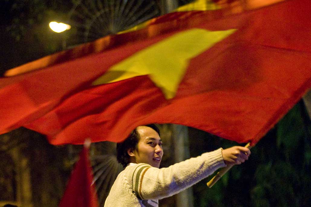 image of AARONTAIT COPYRIGHTED 2014 479 VIETNAM GLORY VICTORY FOOTBALL CELEBRATION HANOI FANS PATRIOTISM HAPPY RIOT FLARE DOCUMENTARY REPORTAGE PHOTOGRAPHER 