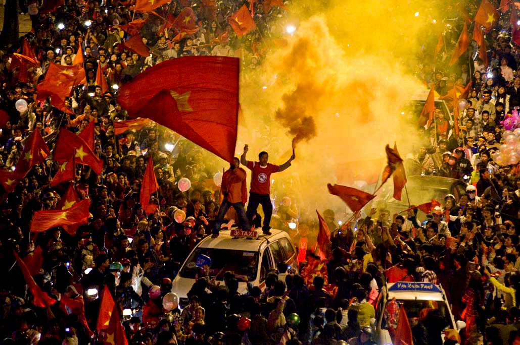 image of AARONTAIT COPYRIGHTED 2014 486 VIETNAM GLORY VICTORY FOOTBALL CELEBRATION HANOI FANS PATRIOTISM HAPPY RIOT FLARE DOCUMENTARY REPORTAGE PHOTOGRAPHER 