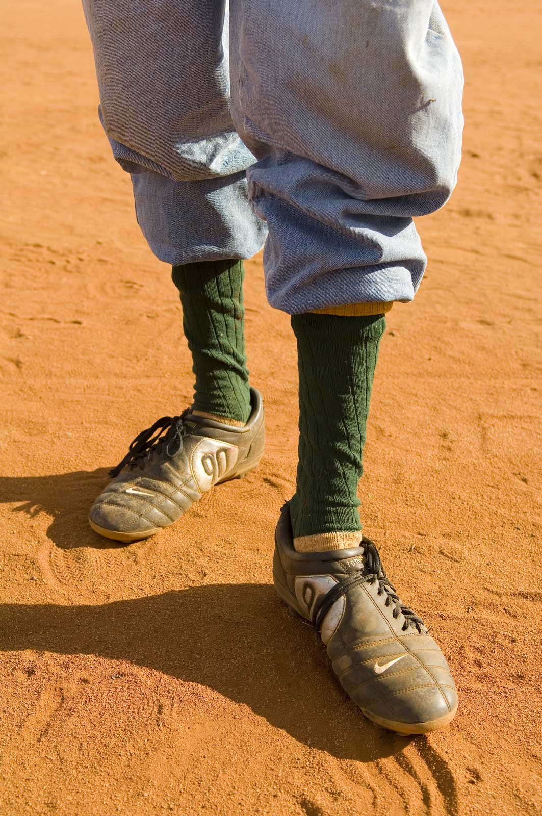 image of AARONTAIT-COPYRIGHTED-2014-5332 EDITORIAL DOCUMENTARY PHOTOGRAPHER PAPUNYA NORTHERN TERRITORY AUSTRALIA LANDSCAPE LIFE PEOPLE ART INDIGENOUS PINTUPI LURITJA PAPUNYA TULA FOOTY BOOTS AUSTRALIA OUTBACK