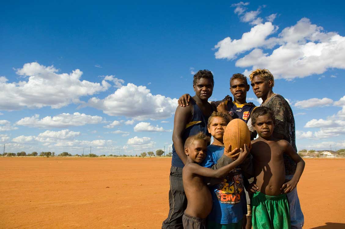 image of AARONTAIT COPYRIGHTED 2014 5372 EDITORIAL DOCUMENTARY PHOTOGRAPHER PAPUNYA NORTHERN TERRITORY AUSTRALIA LANDSCAPE LIFE PEOPLE ART INDIGENOUS PINTUPI LURITJA PAPUNYA TULA PORTRAIT KIDS FOOTBALL AFL TEA